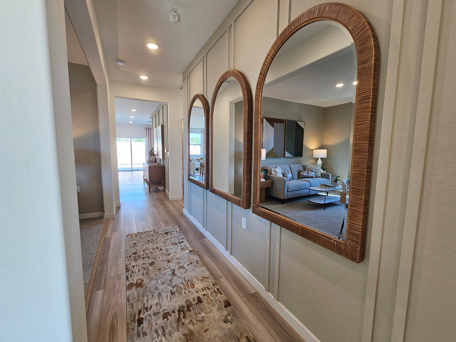 A large bedroom with a large mirror.