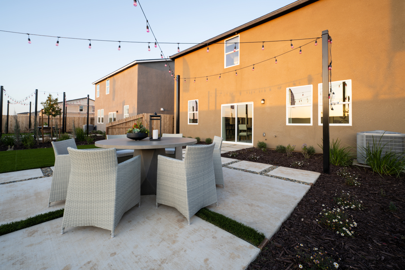 A patio with a table and chairs.