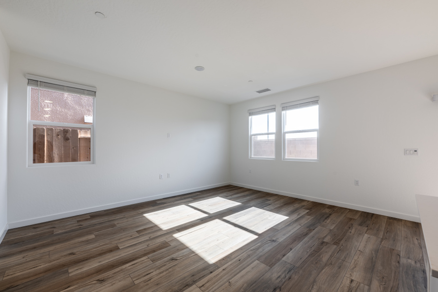 A room with windows and wood floor.