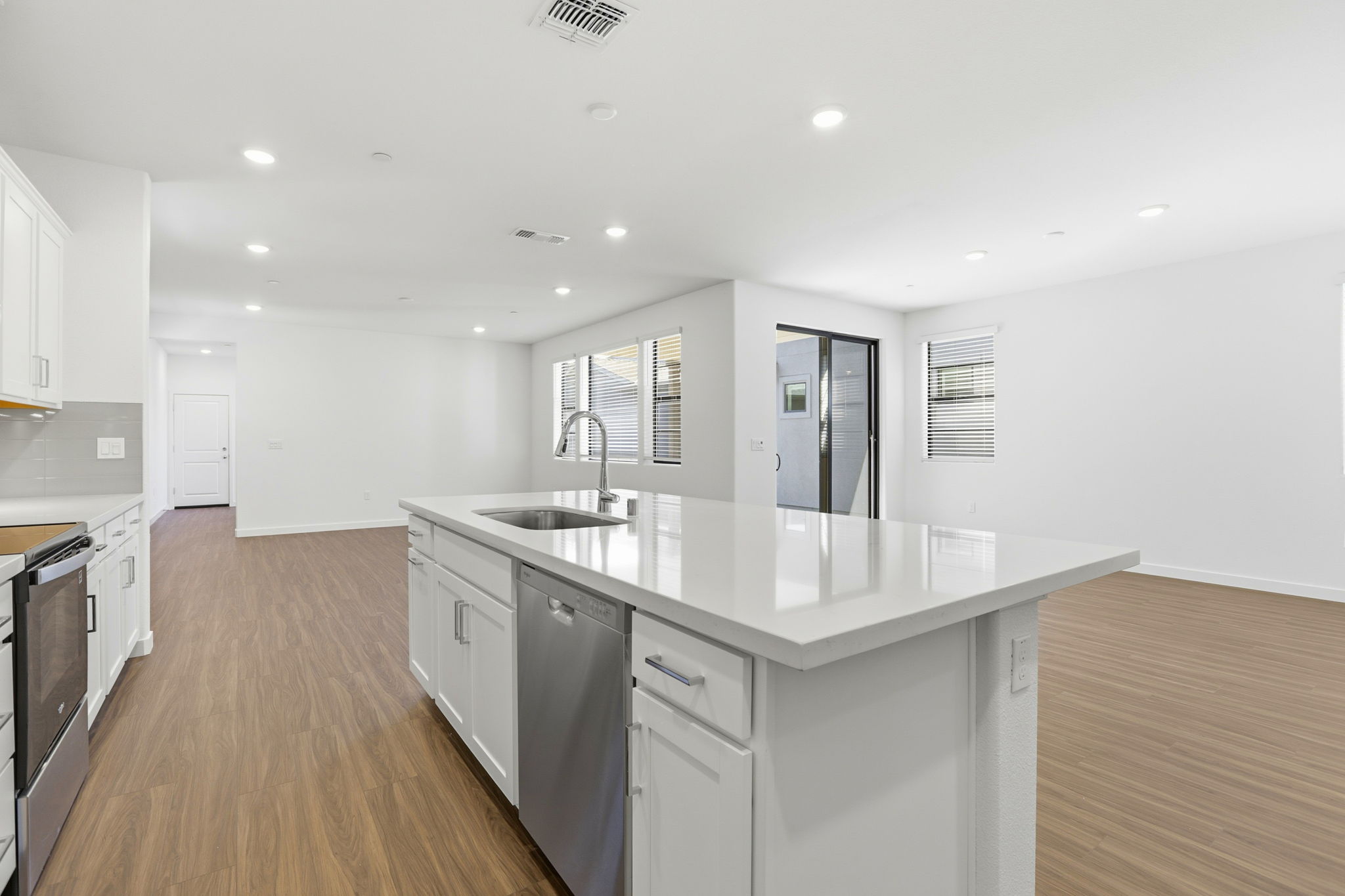 A kitchen with white cabinets.