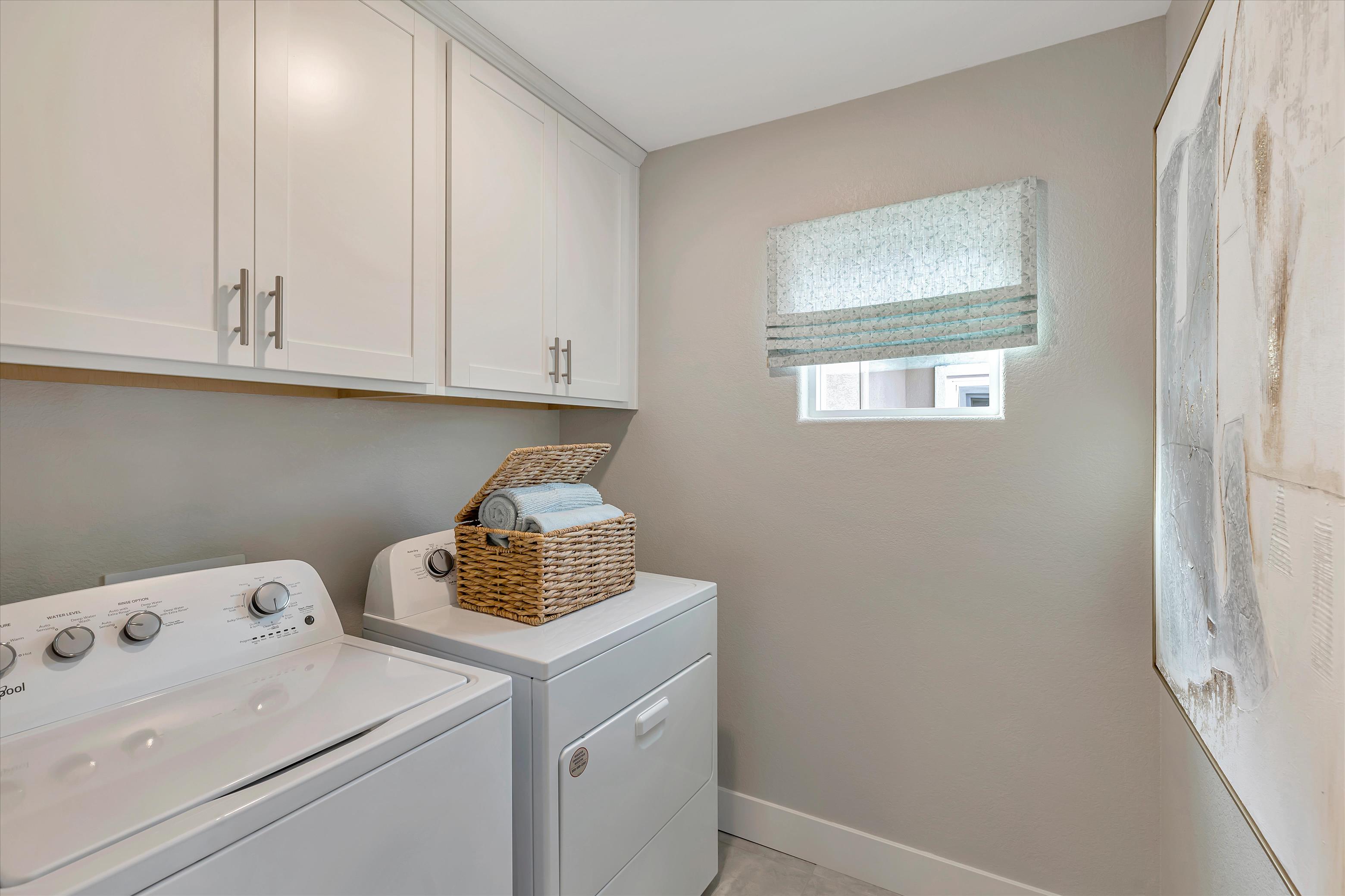 A kitchen with white cabinets.