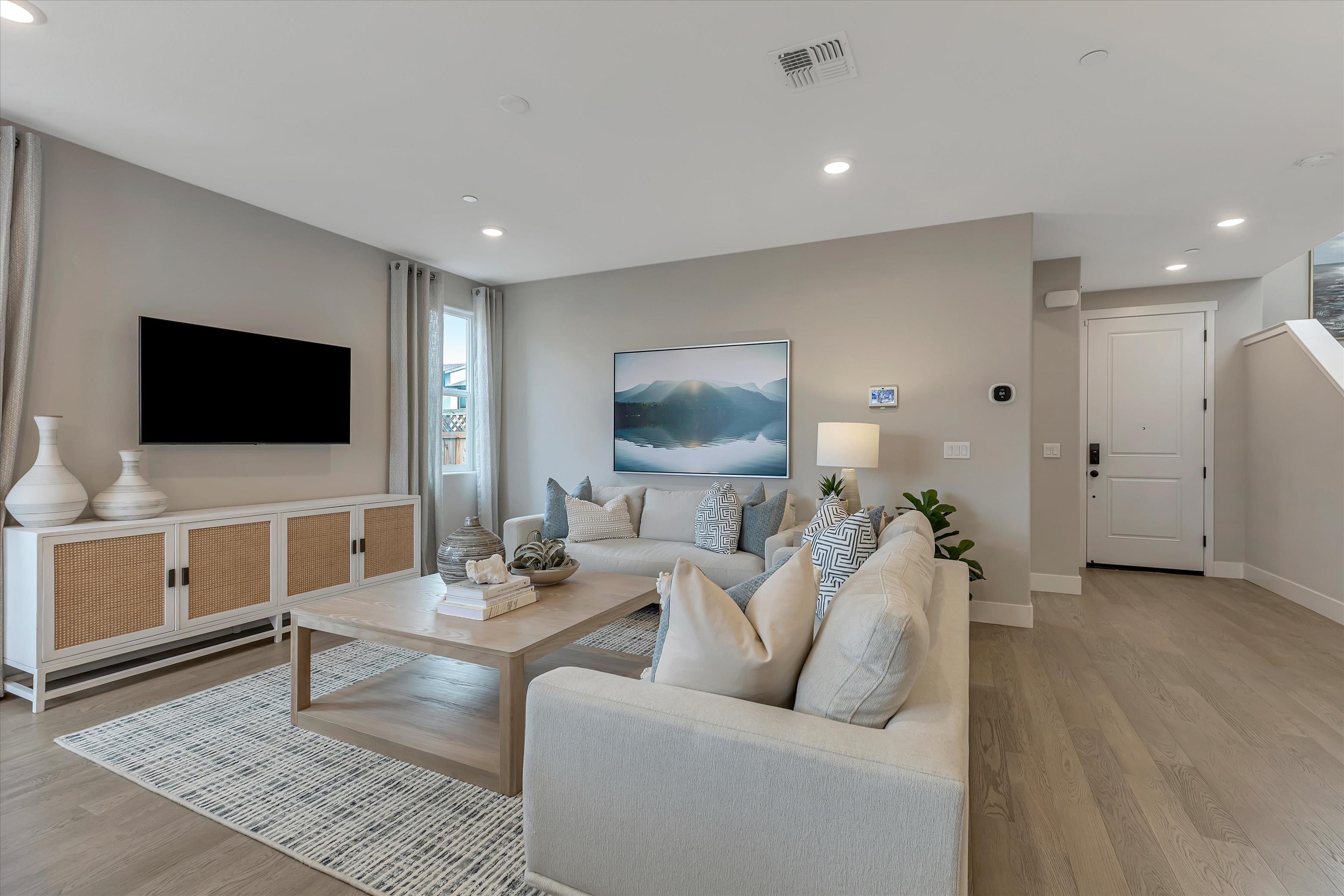 A living room with a large television.