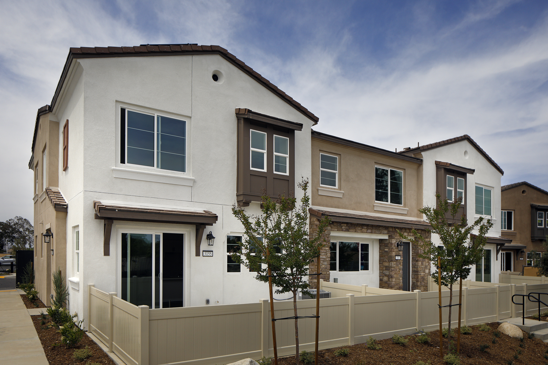 A white house with a fence.