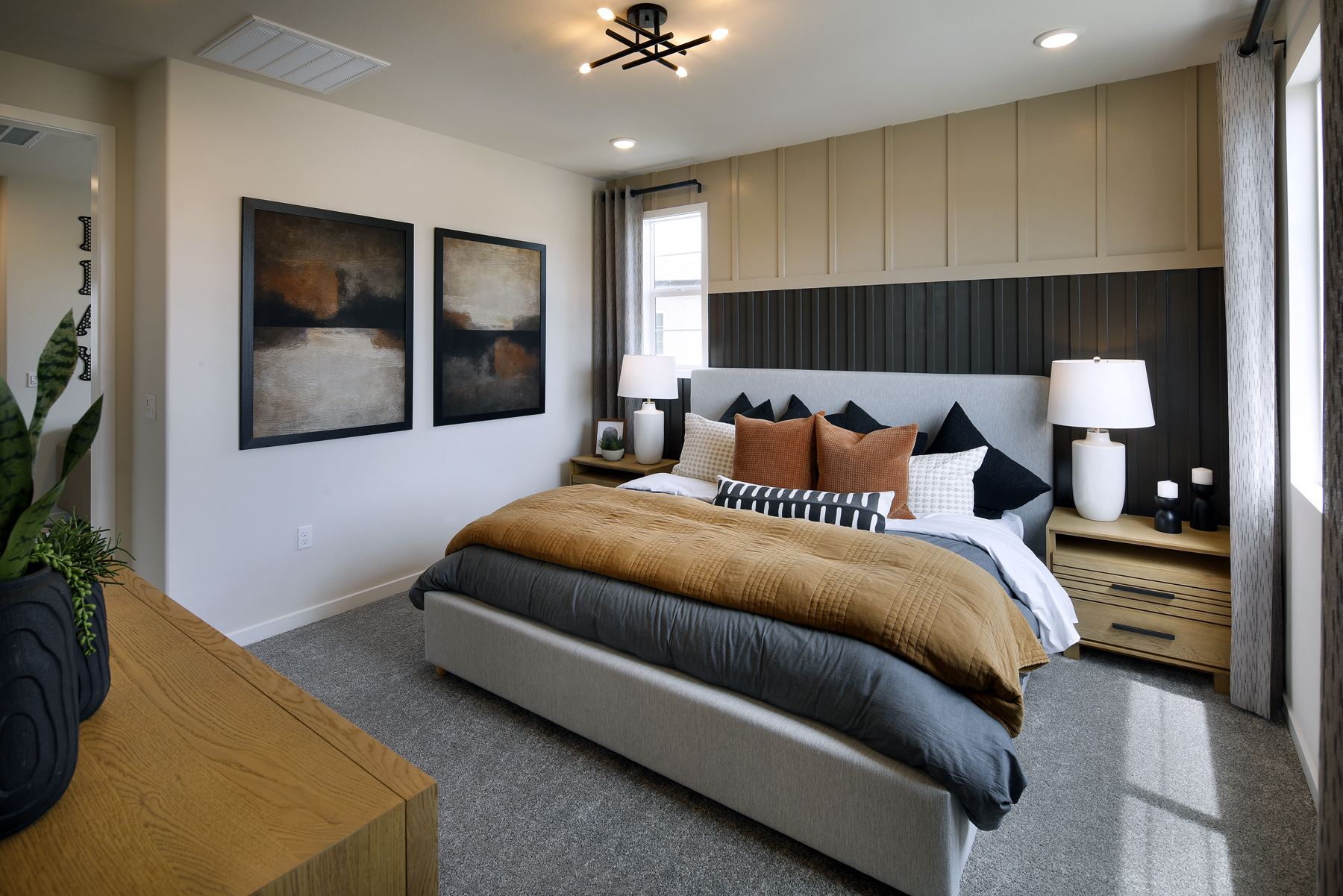 A bedroom with a bed and lamps.