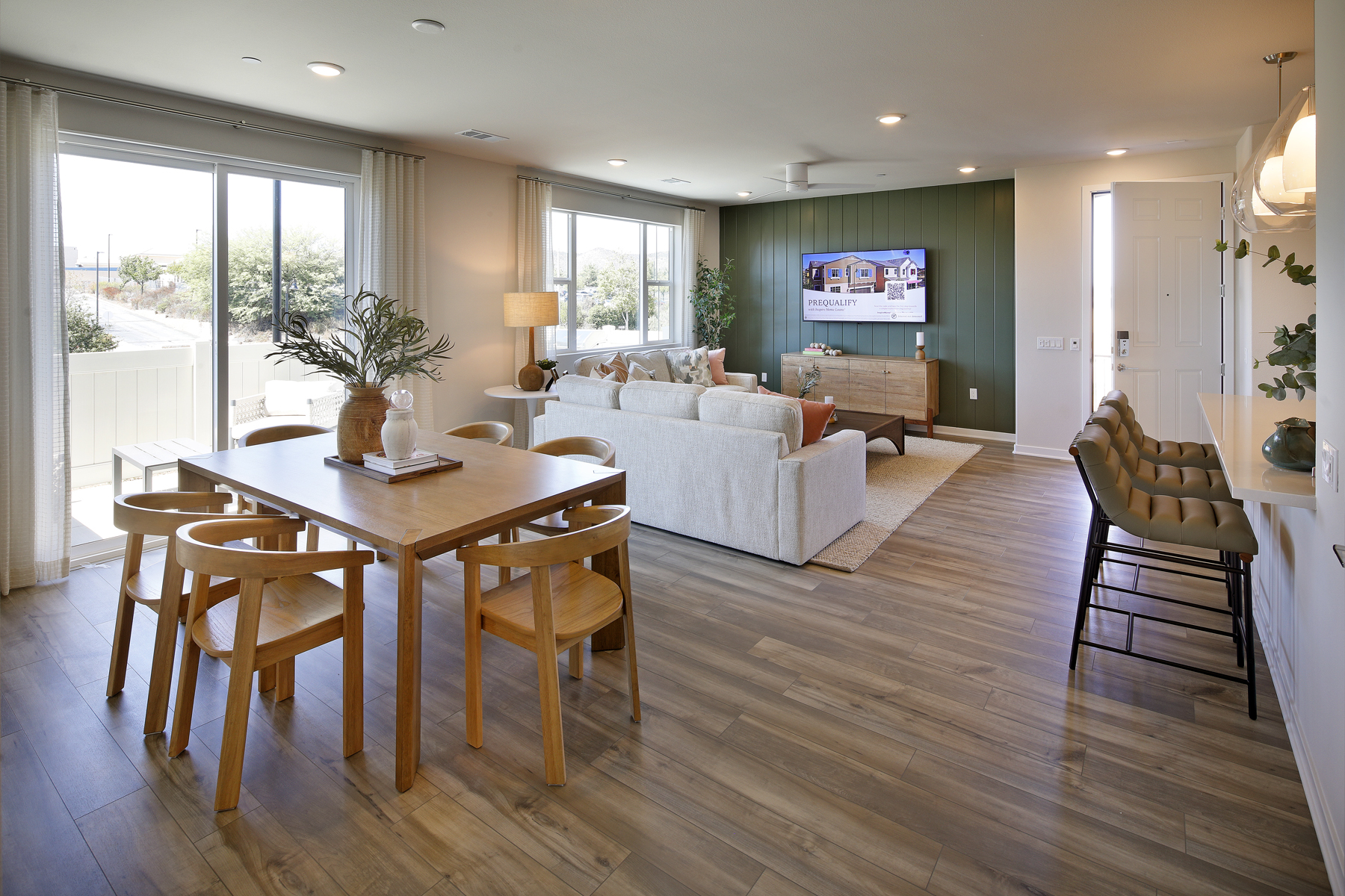 A living room with a large table and chairs.