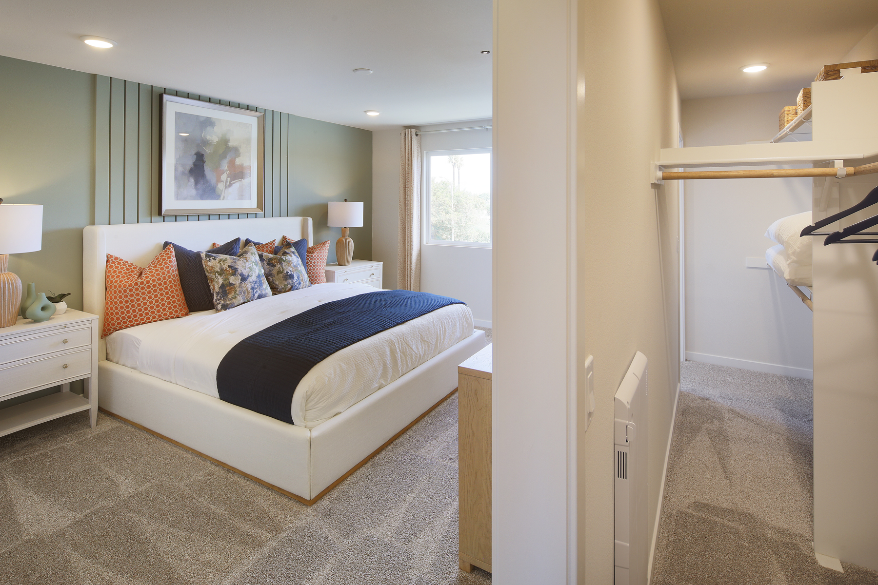 A bedroom with a bed and lamps.