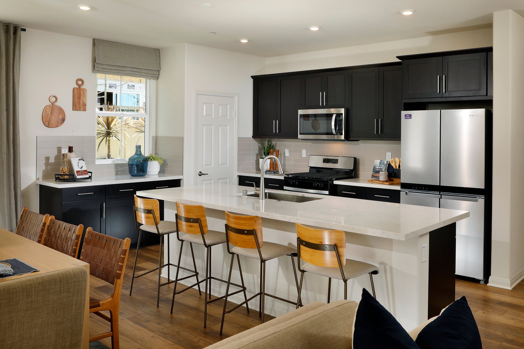 A kitchen with black cabinets.