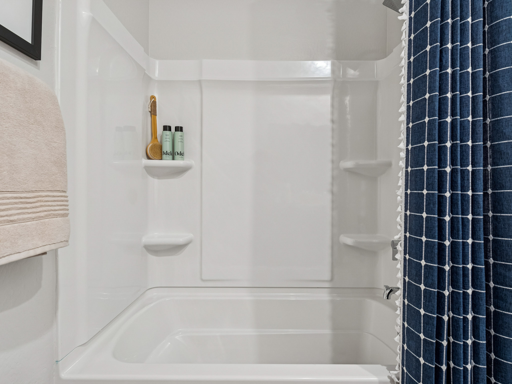 A bathroom with a shower and sink.