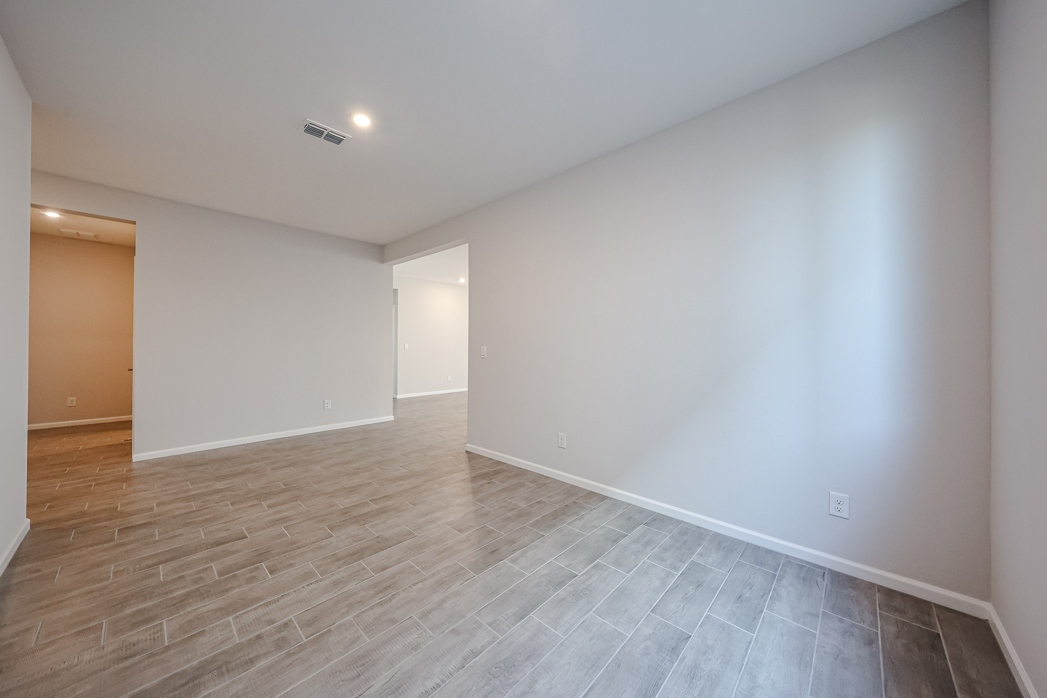 A room with a wood floor and a wood floor.