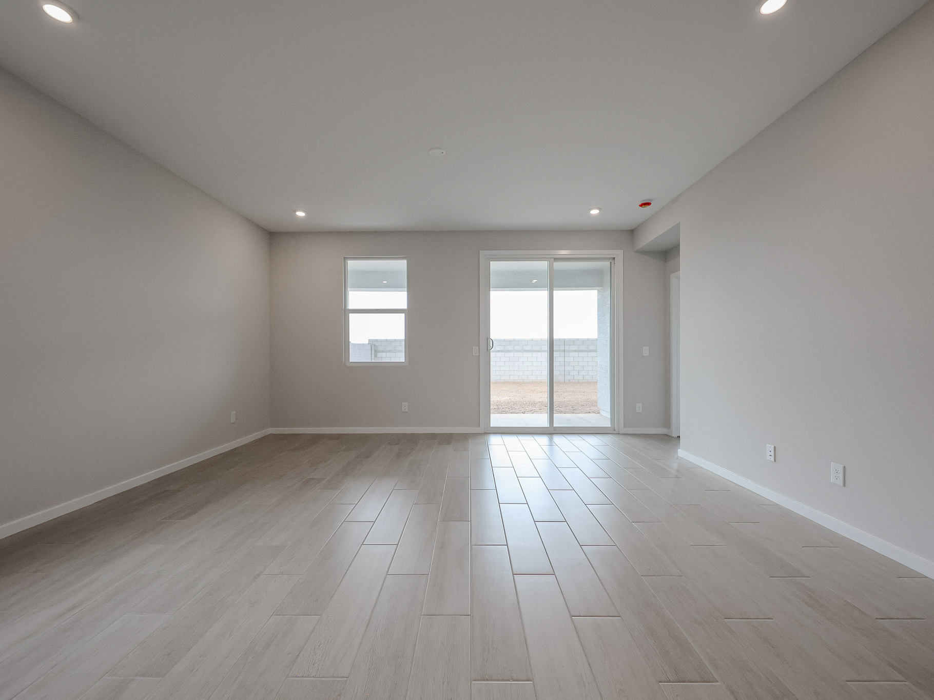 A room with a wood floor and windows.