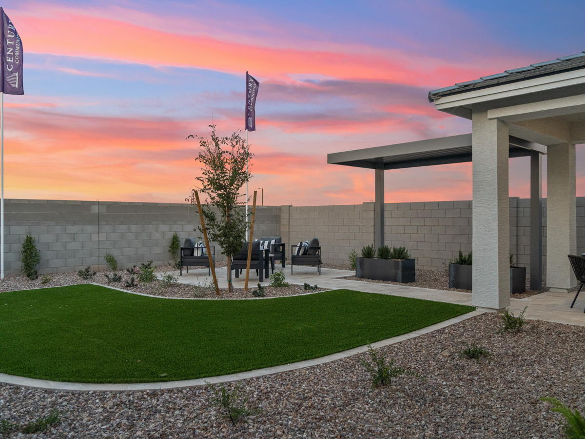 A building with a lawn and a tree in front of it.
