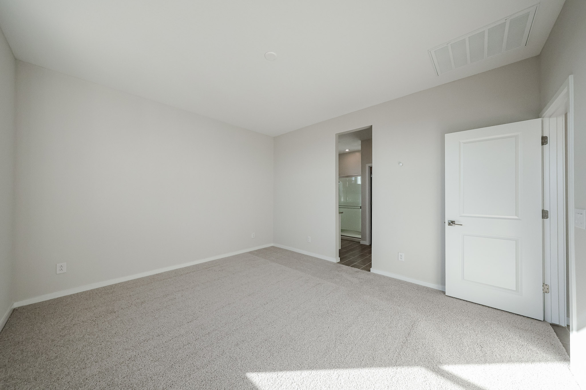 A hallway with white doors.