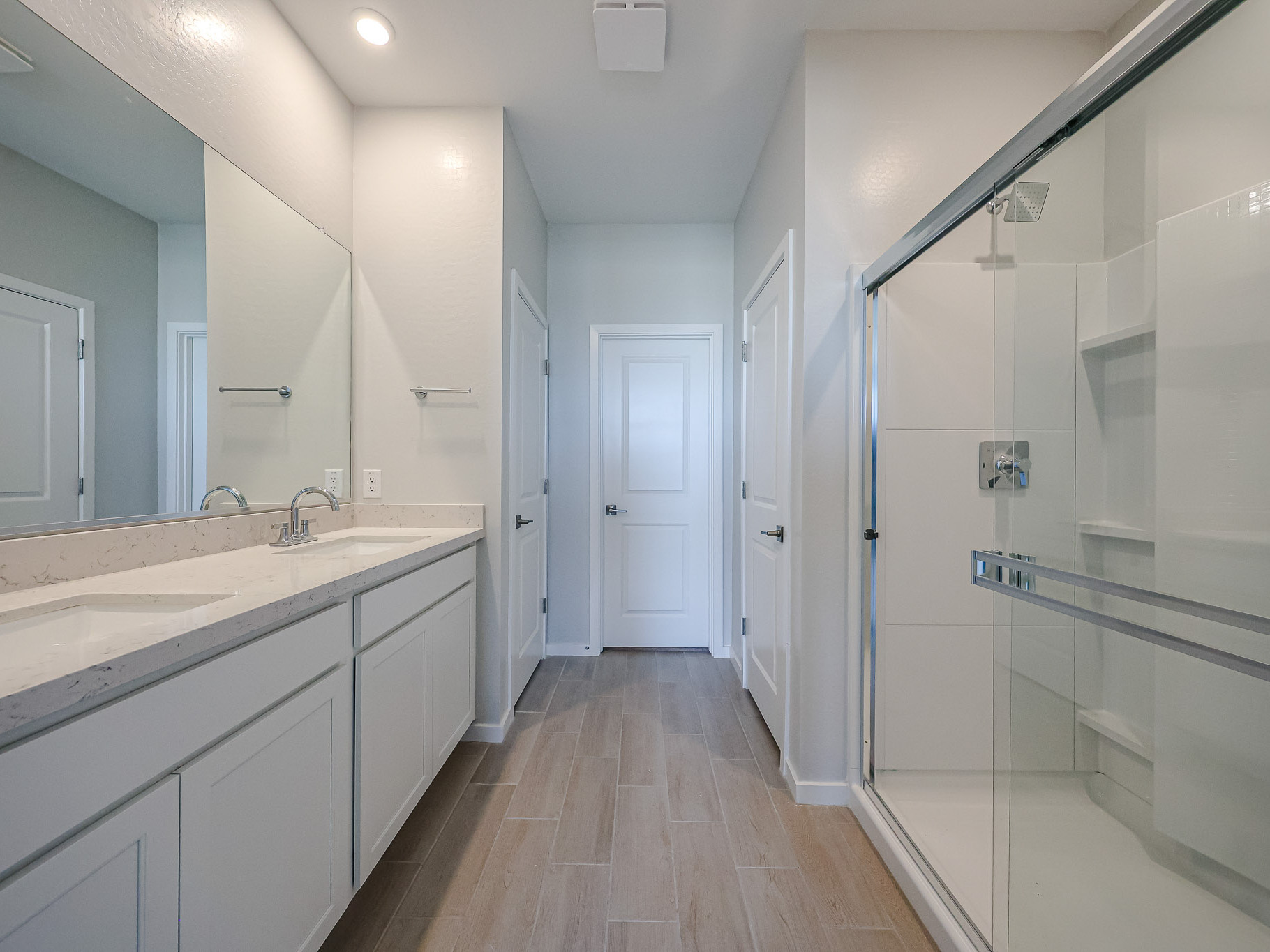 A bathroom with white cabinets.