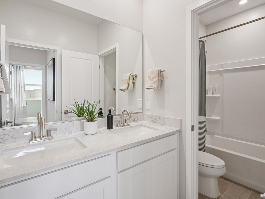 A bathroom with a tub sink and toilet.