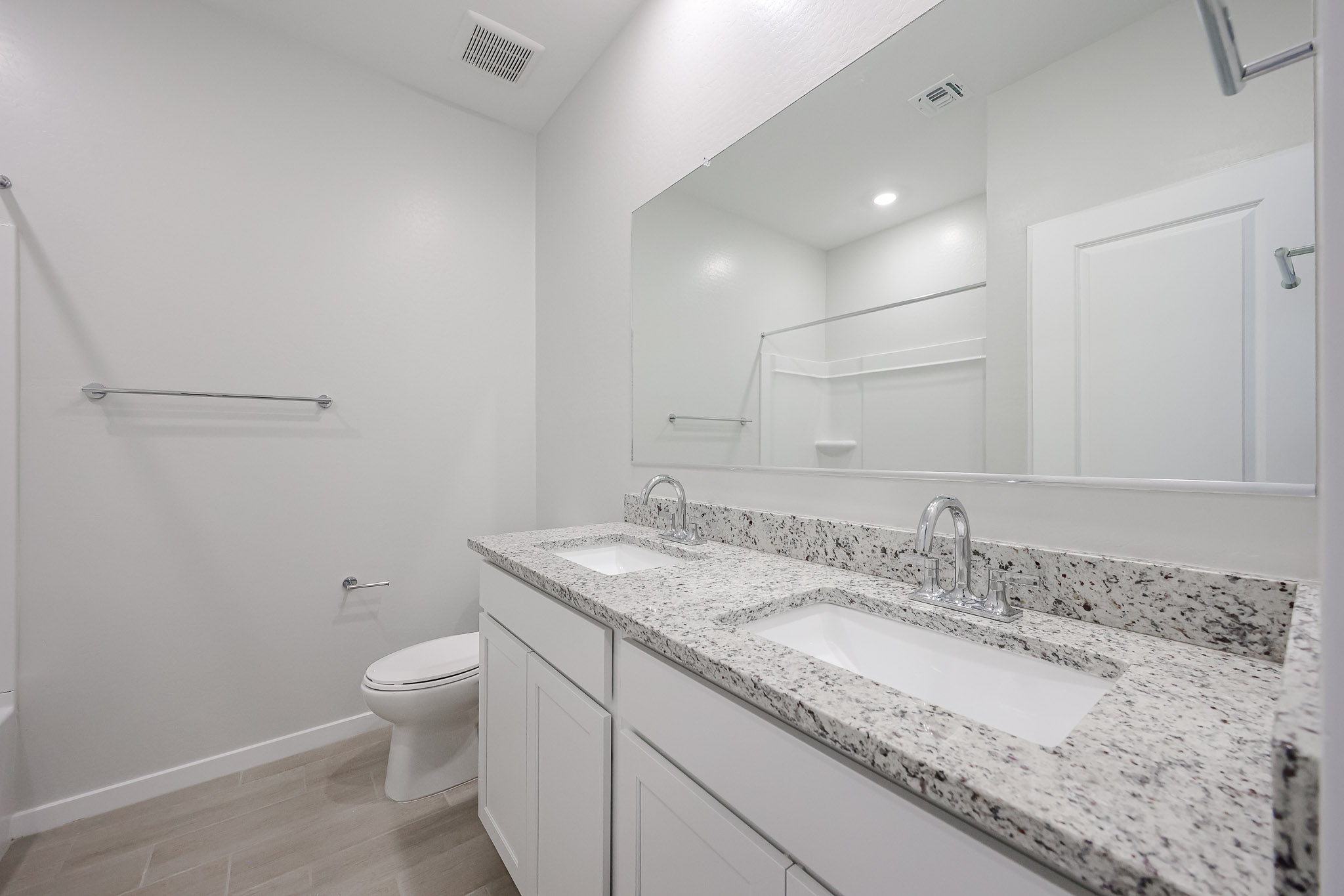 A bathroom with a marble countertop.