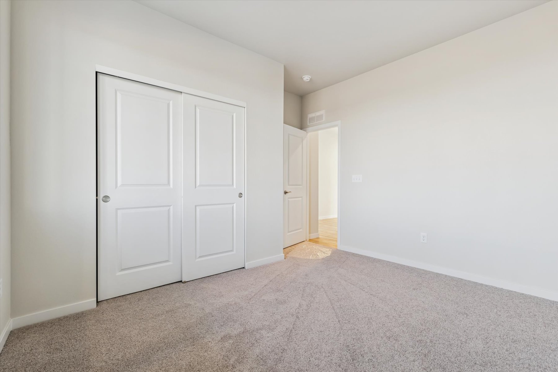 A hallway with white doors.