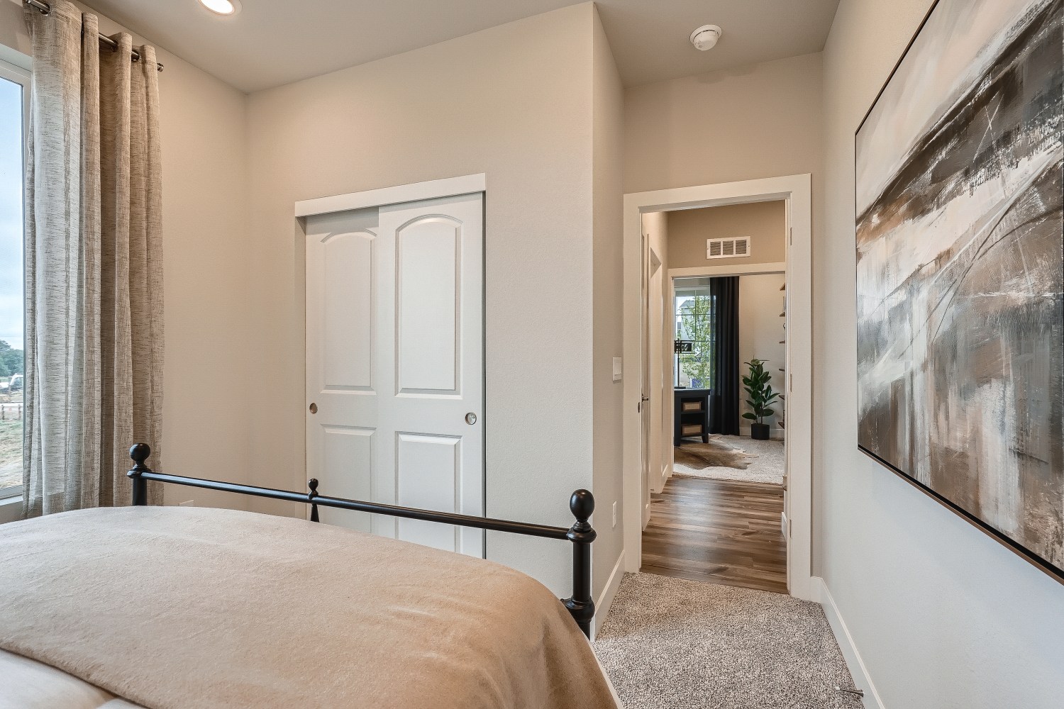 A bedroom with a bed and a door.