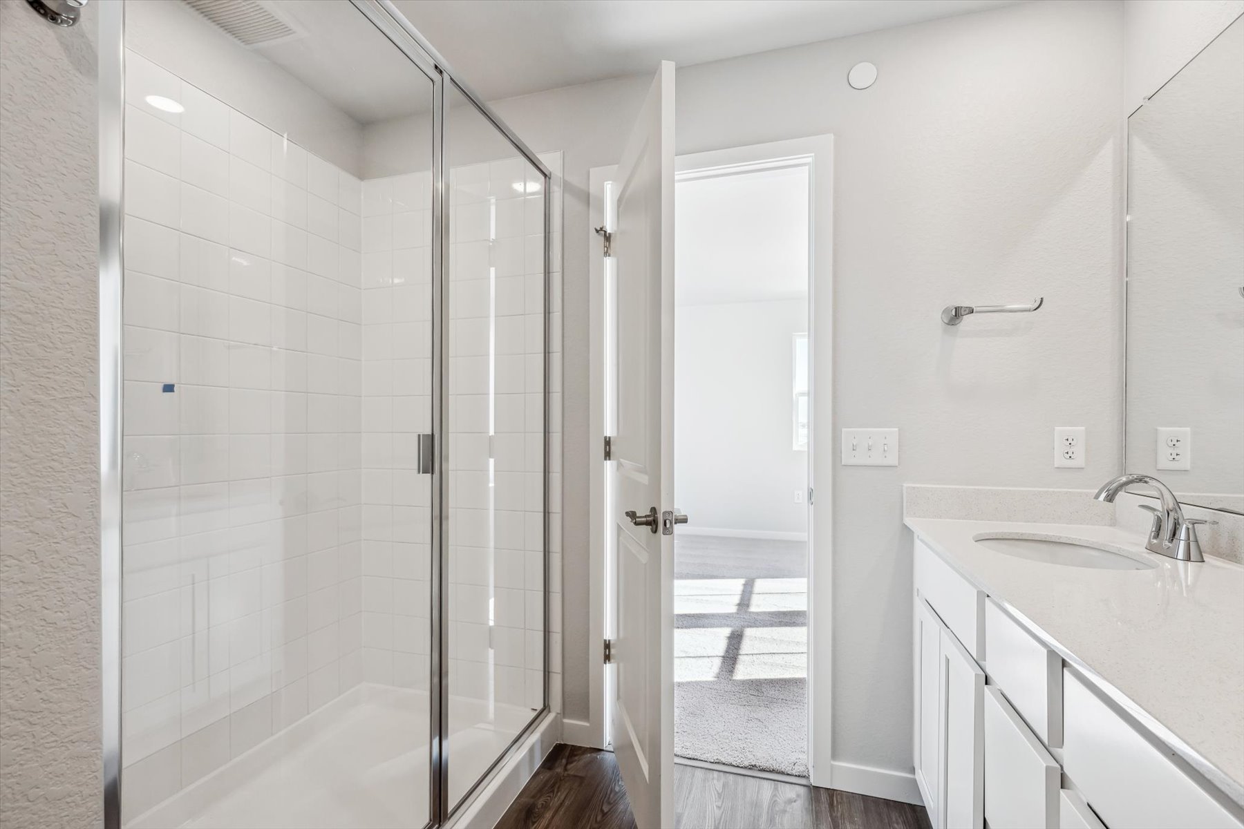 A bathroom with a shower and sink.