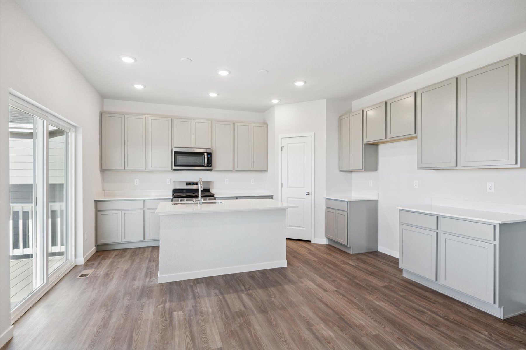 A kitchen with white cabinets.