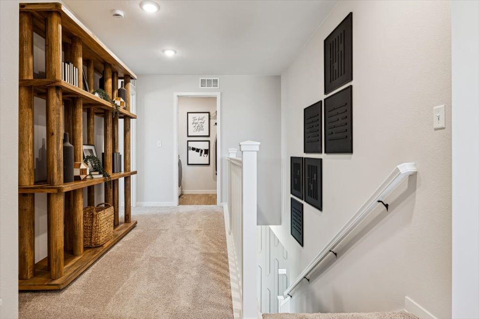 A hallway with a bookcase.