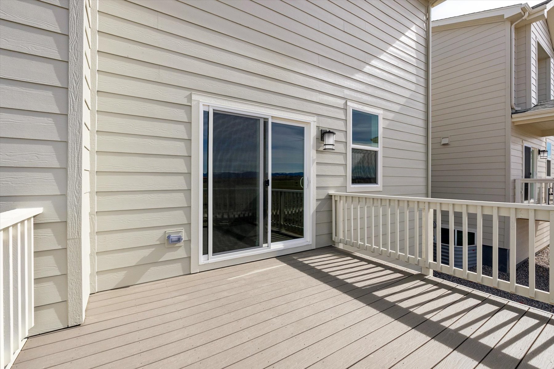A porch with a white railing.
