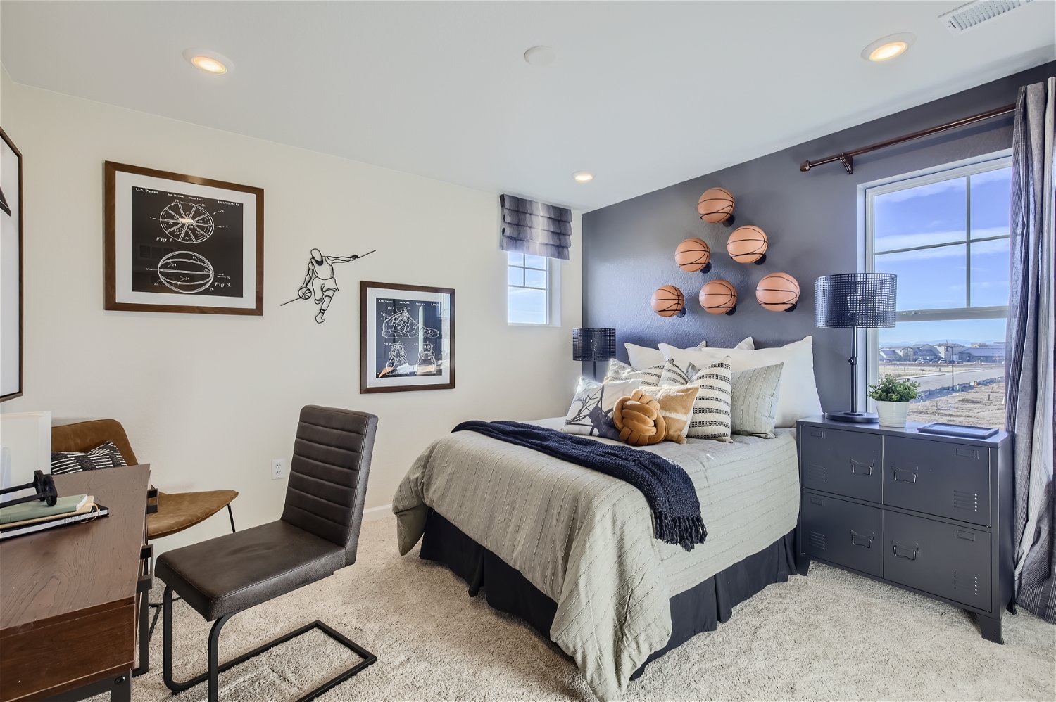 A bedroom with a bed and desk.