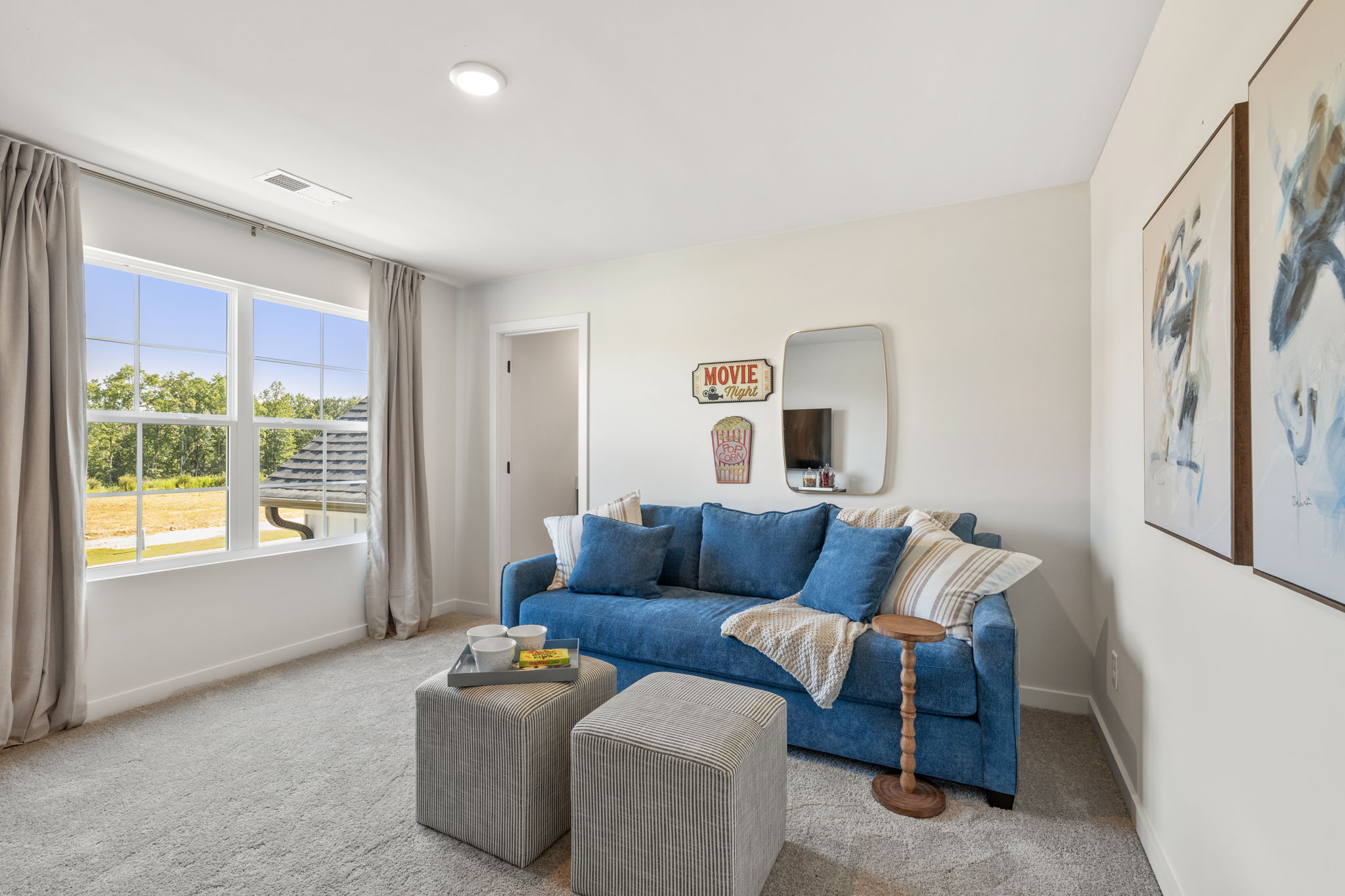 A living room with a blue couch and a blue couch.