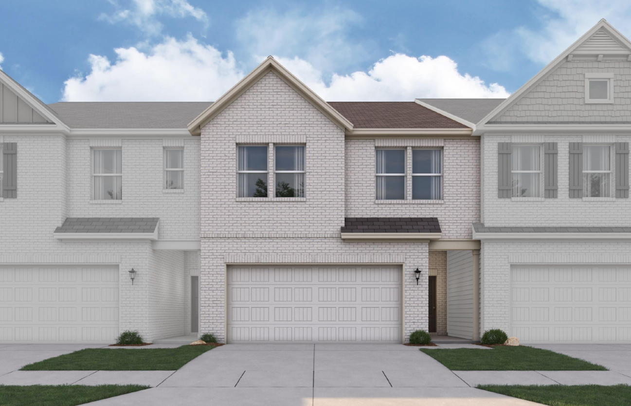 A white house with a garage.