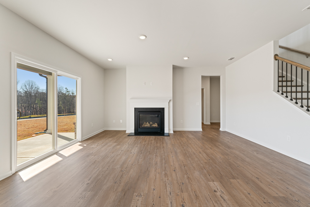 A large white room with a fireplace.
