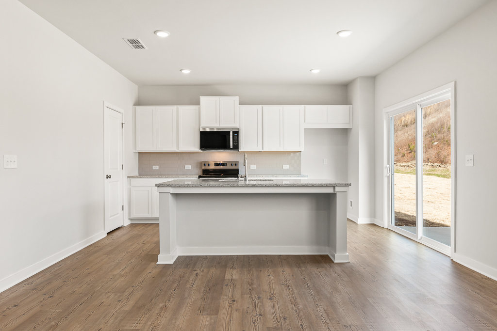 A kitchen with white cabinets.
