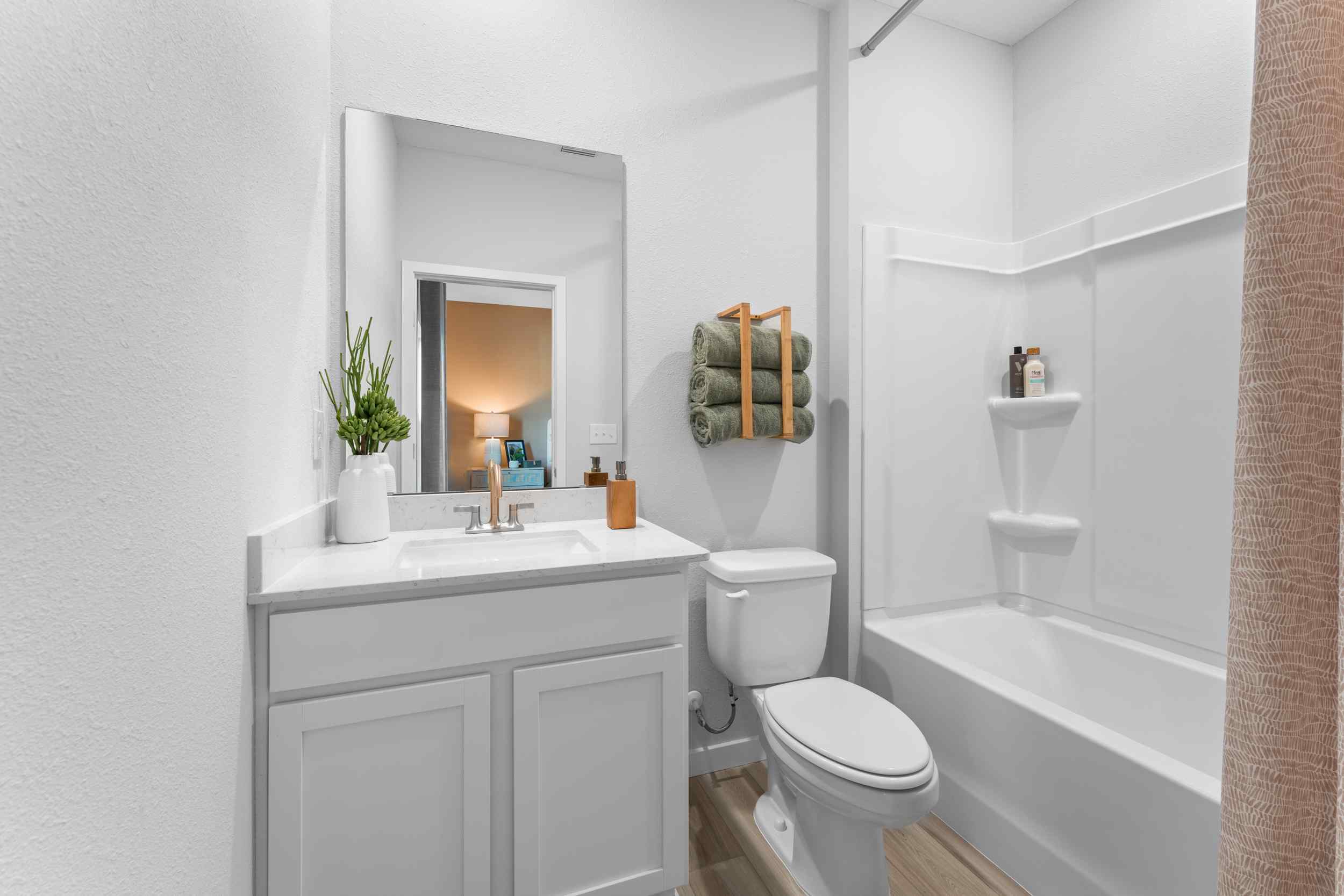A bathroom with a tub sink and toilet.