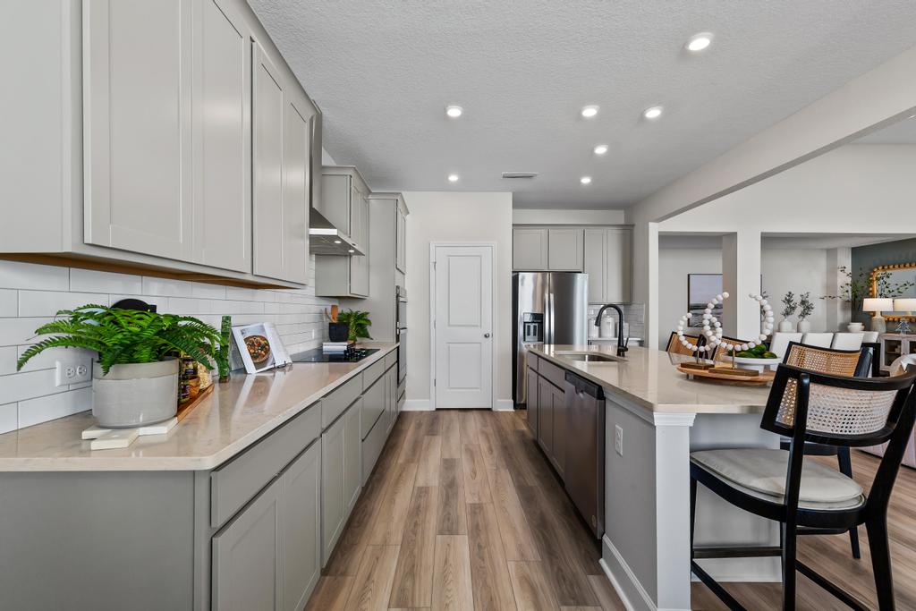 A kitchen with white cabinets.