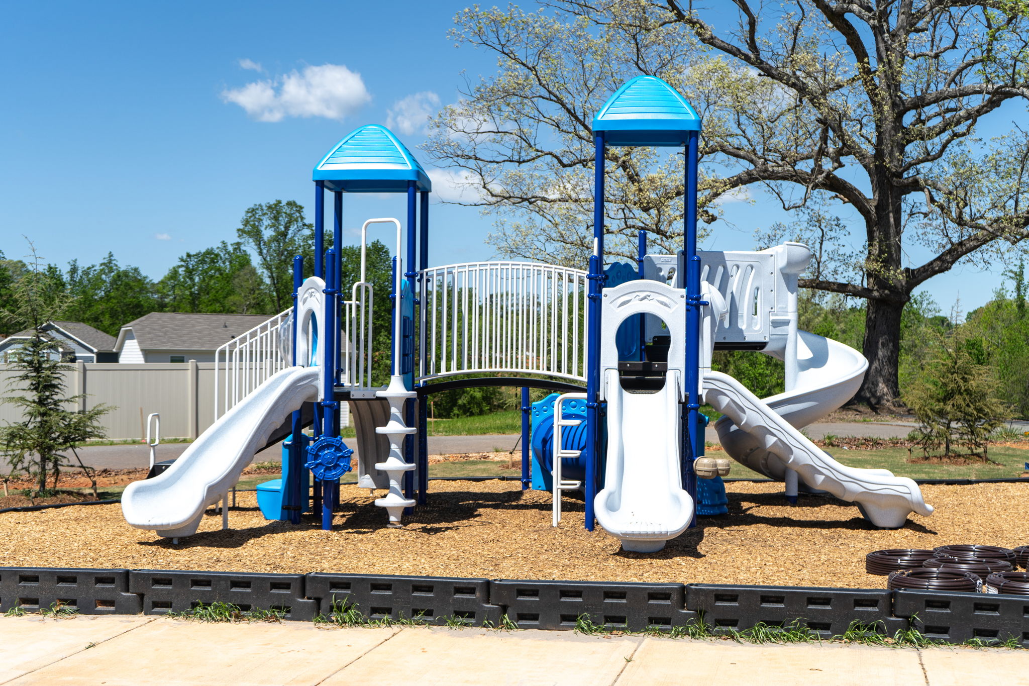 A playground with blue and white slide.
