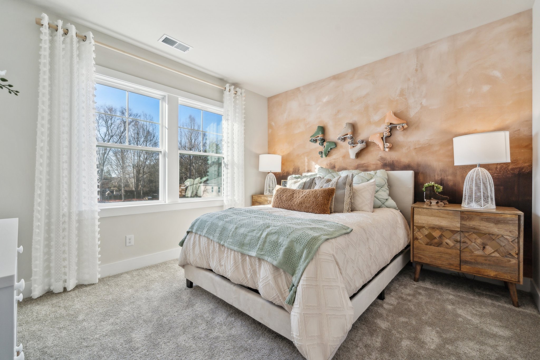 A bedroom with a bed and a dresser.
