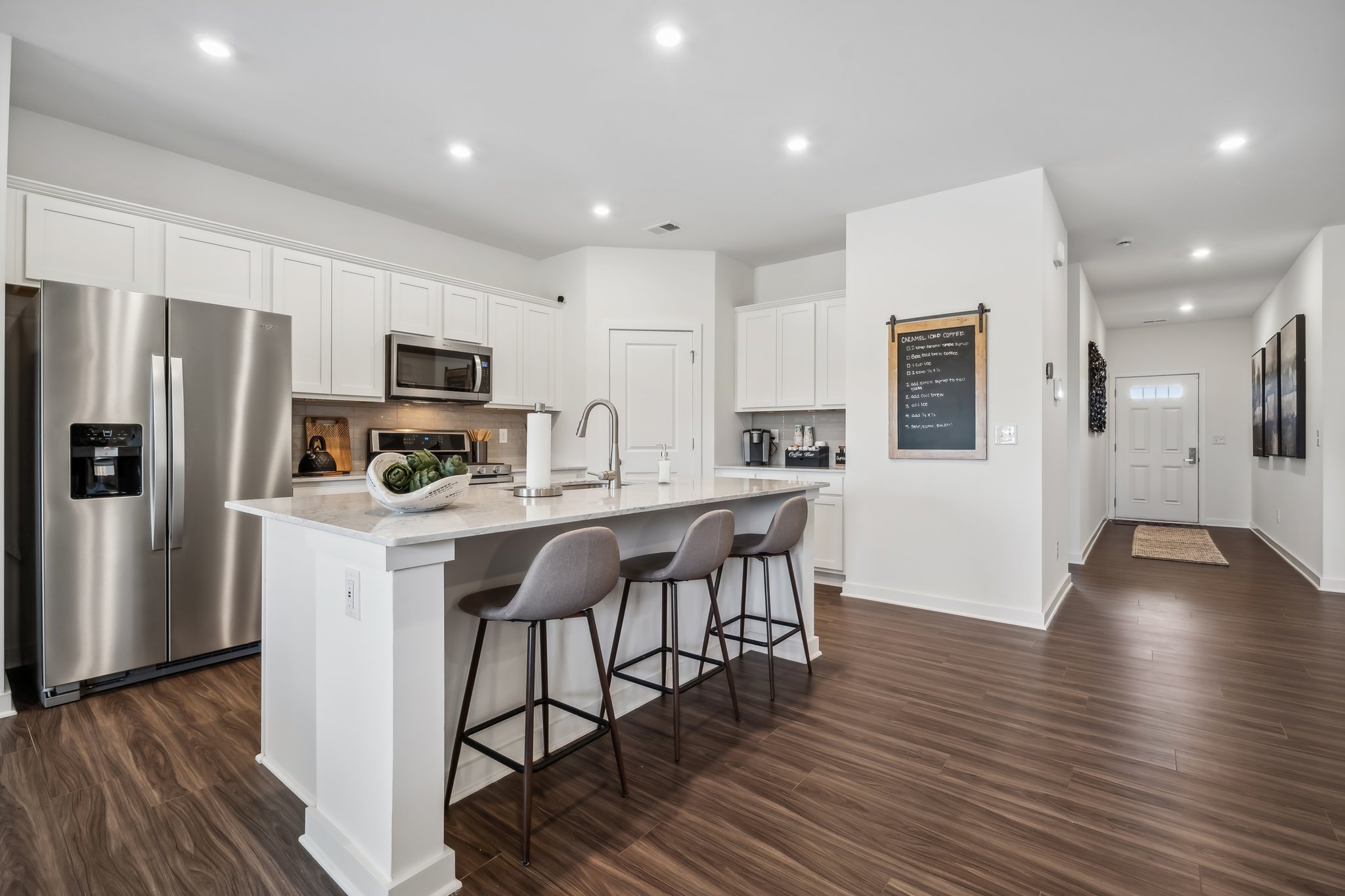 A kitchen with white cabinets.