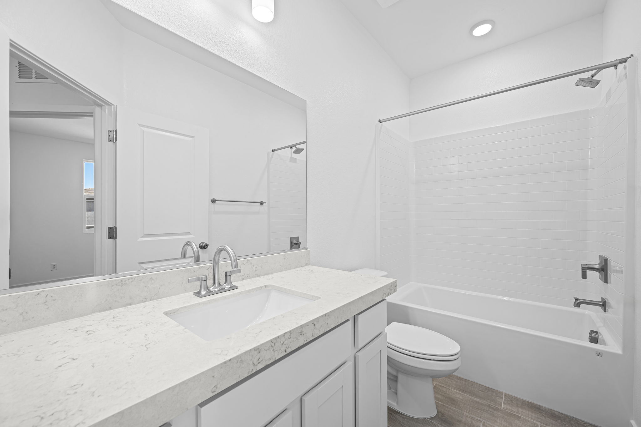 A bathroom with a tub sink and toilet.