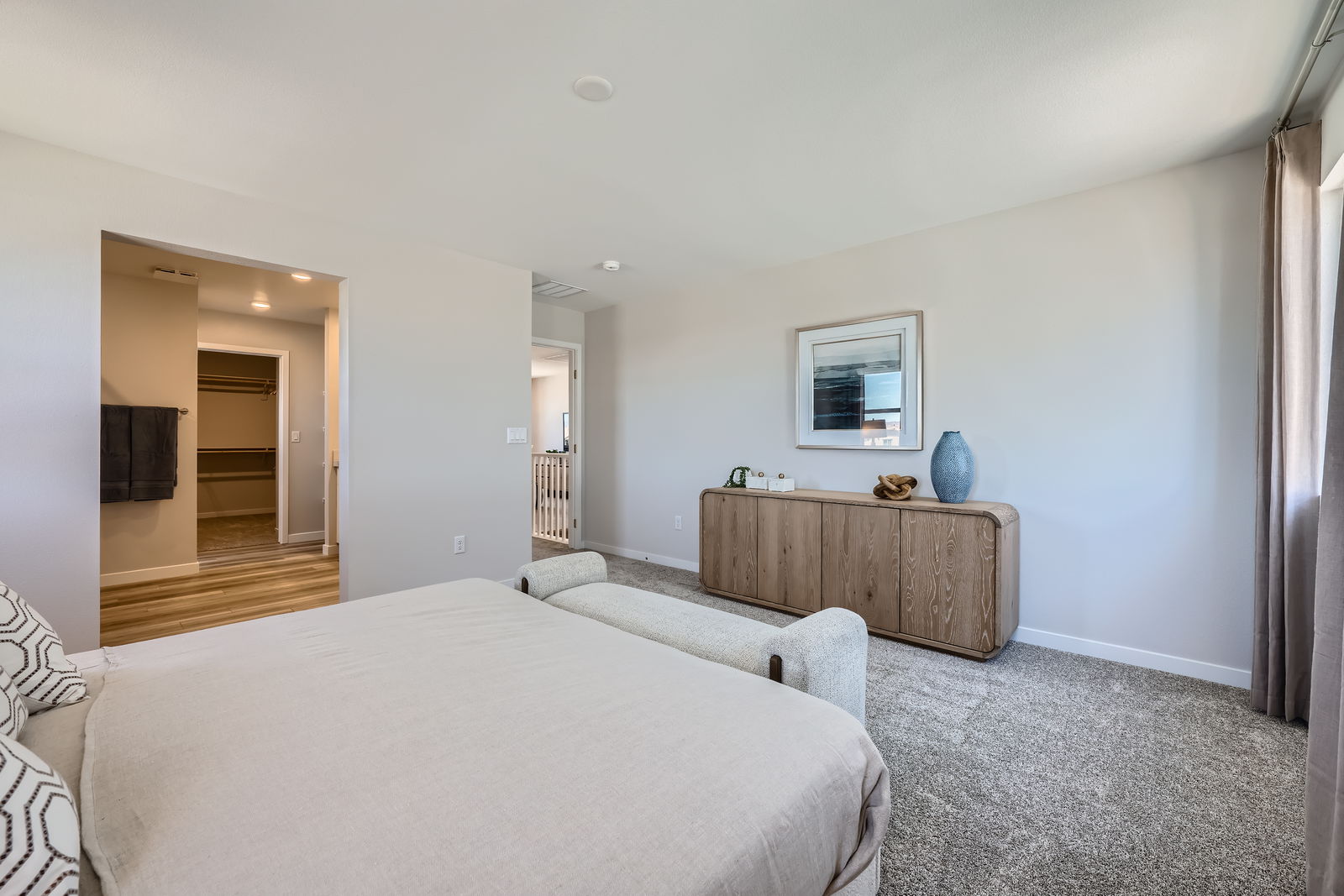 A bedroom with a bed and a table.