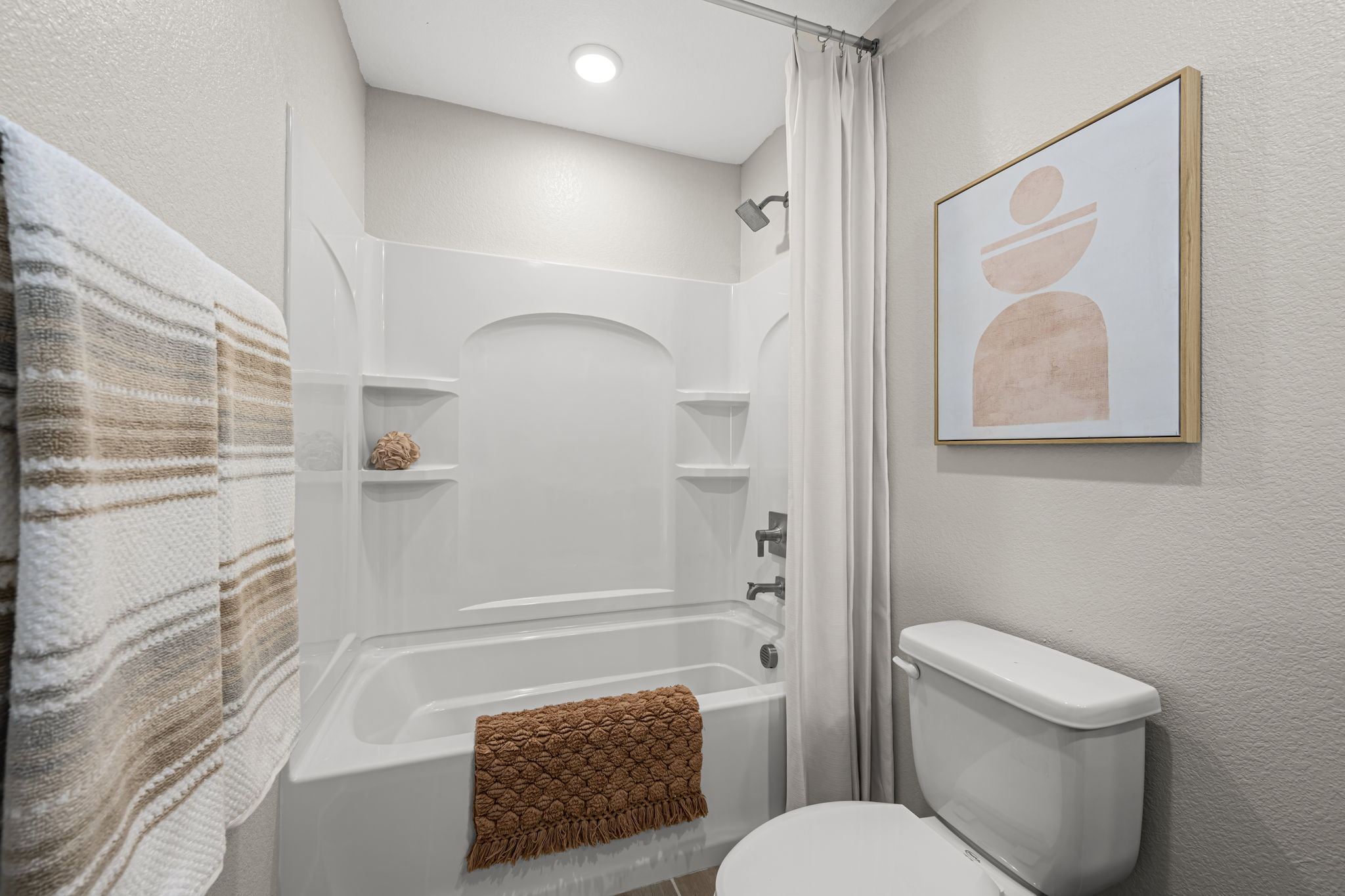 A bathroom with a bathtub and toilet.