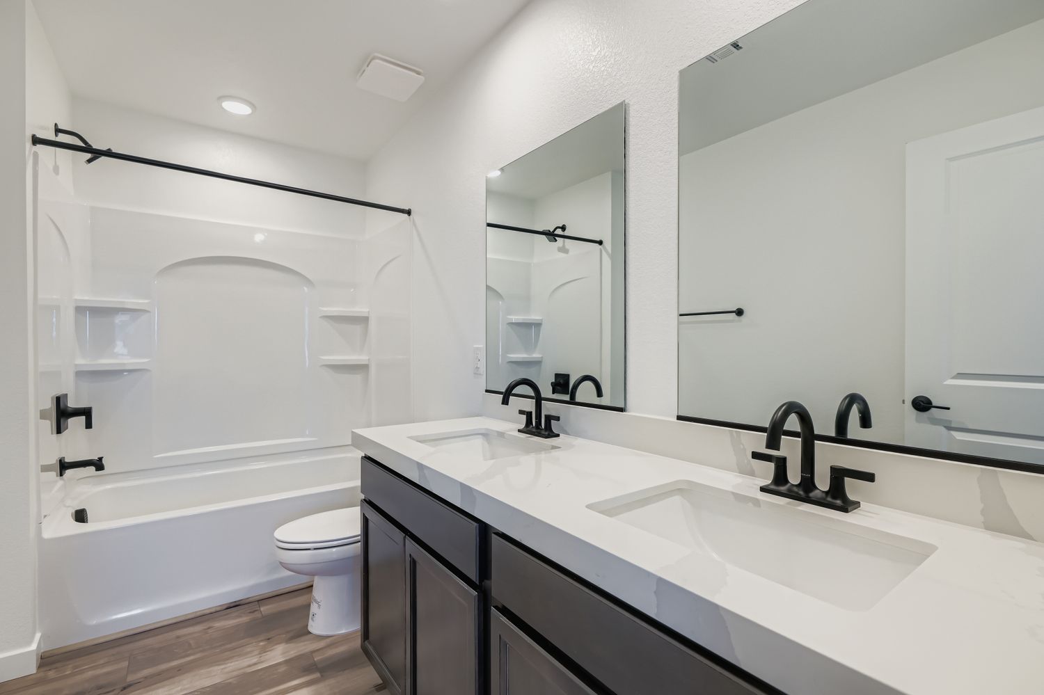 A bathroom with a tub sink and toilet.