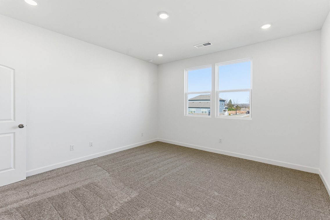 A room with a window and a carpet.