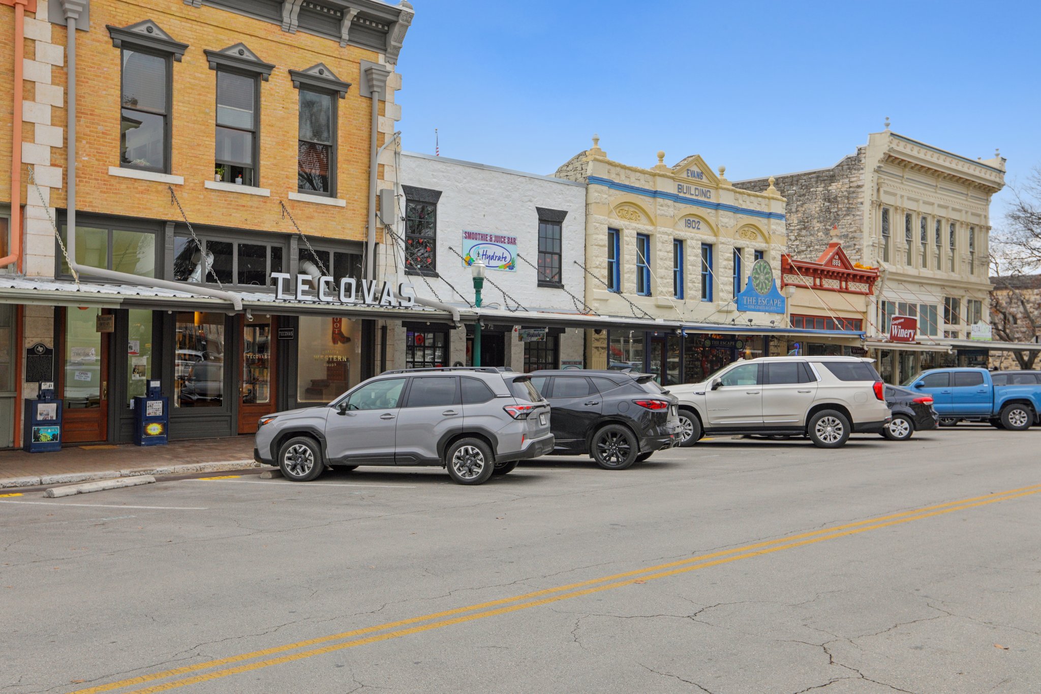 A group of cars parked on the side of a street.