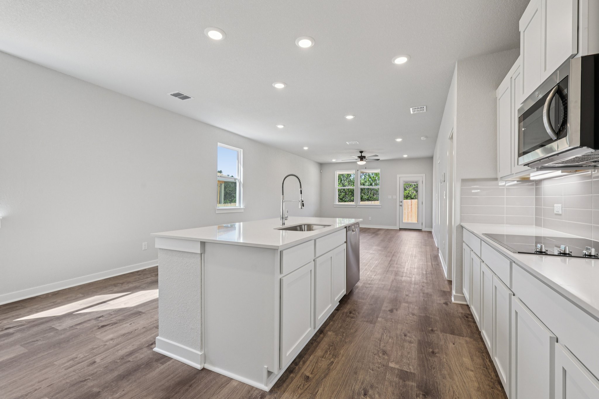 A kitchen with white cabinets.