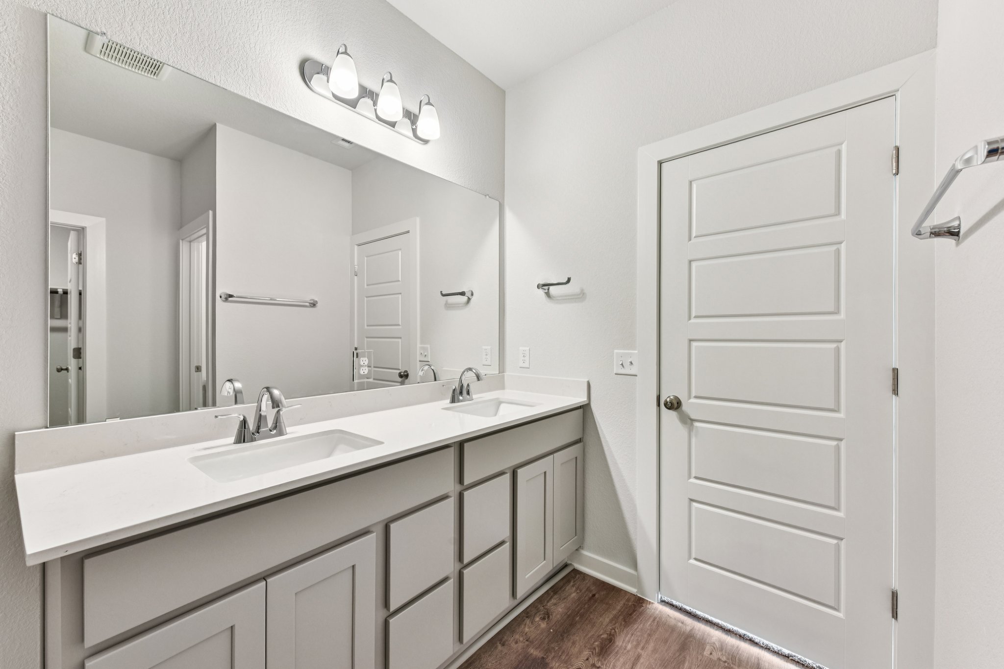 A bathroom with a large mirror.