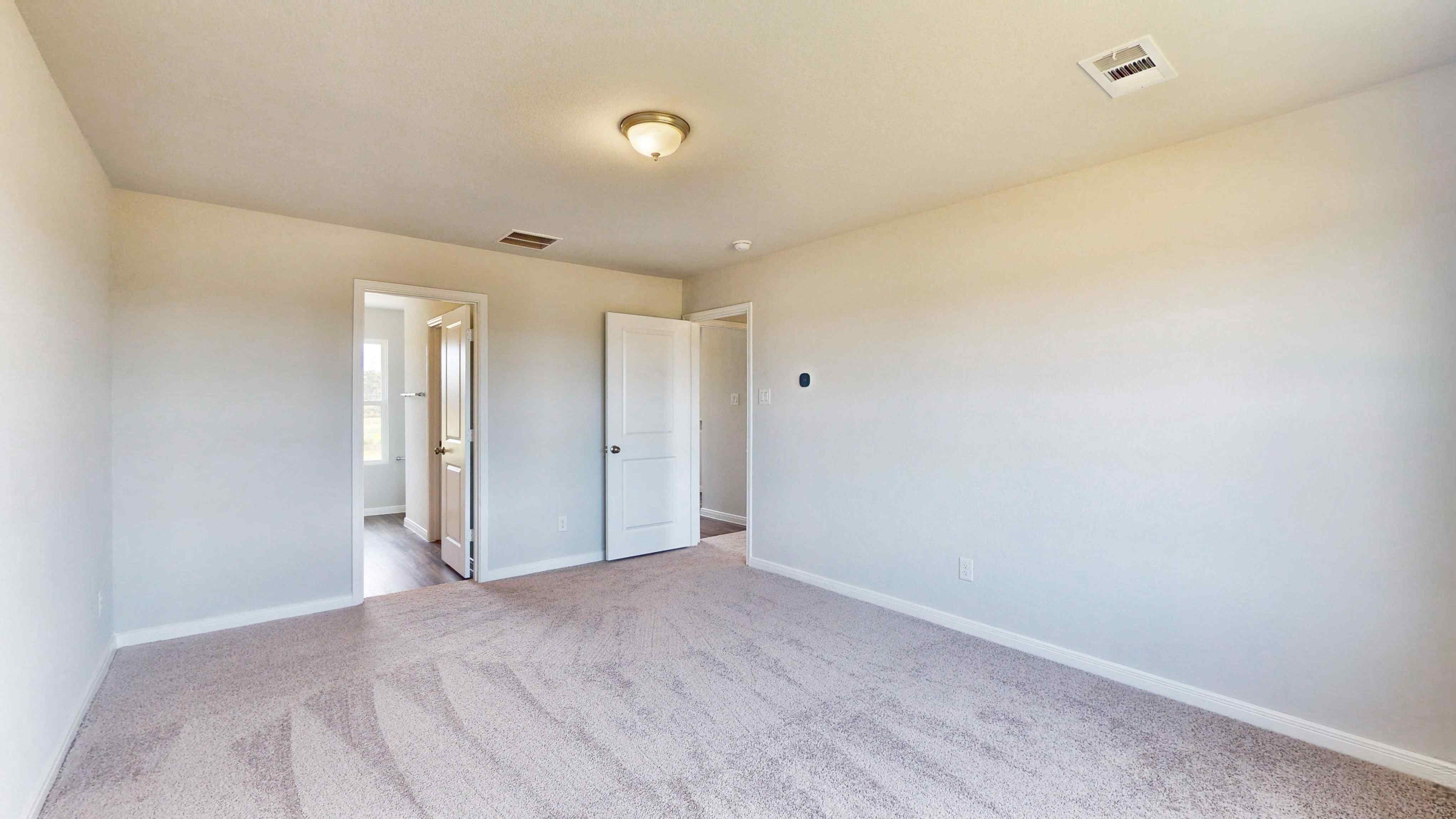A hallway with white walls.