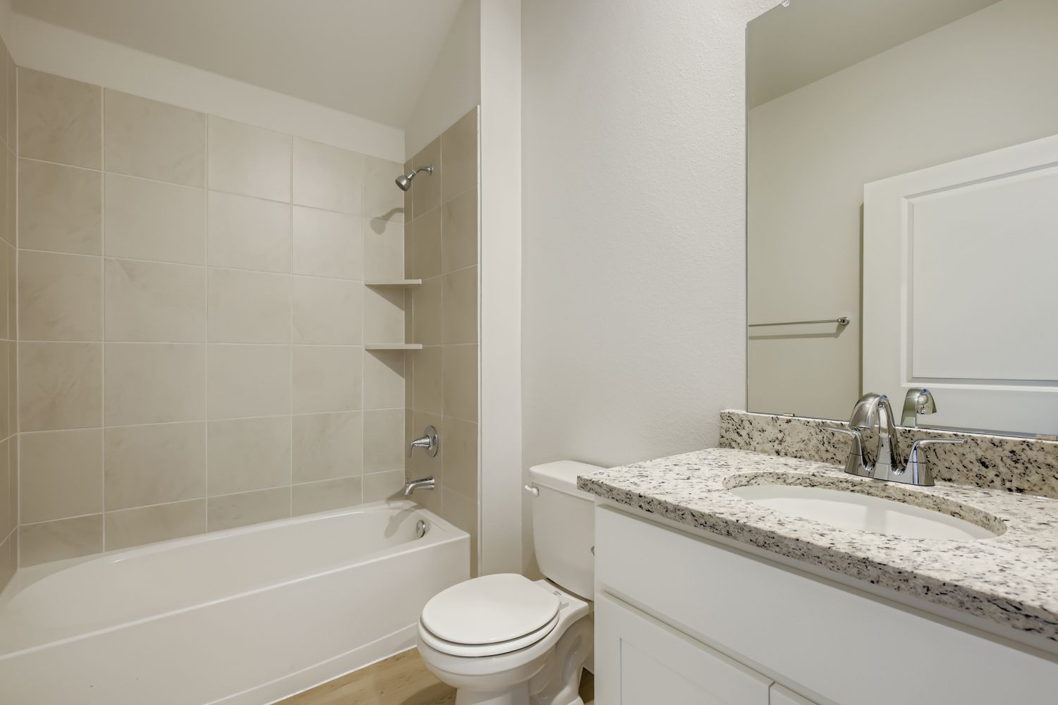 A bathroom with a tub sink and toilet.