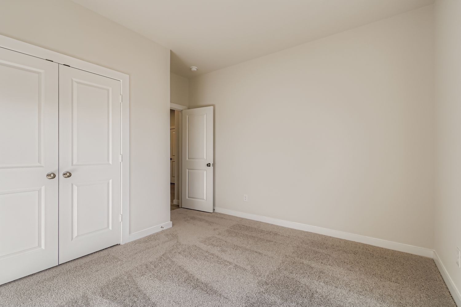 A hallway with white doors.