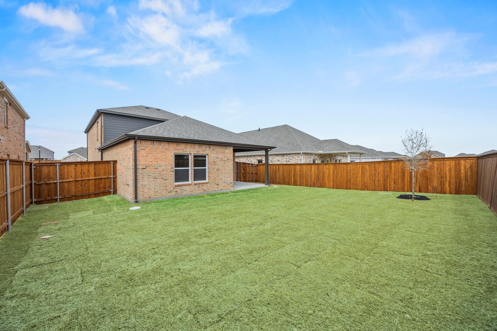 A house with a fence and grass.