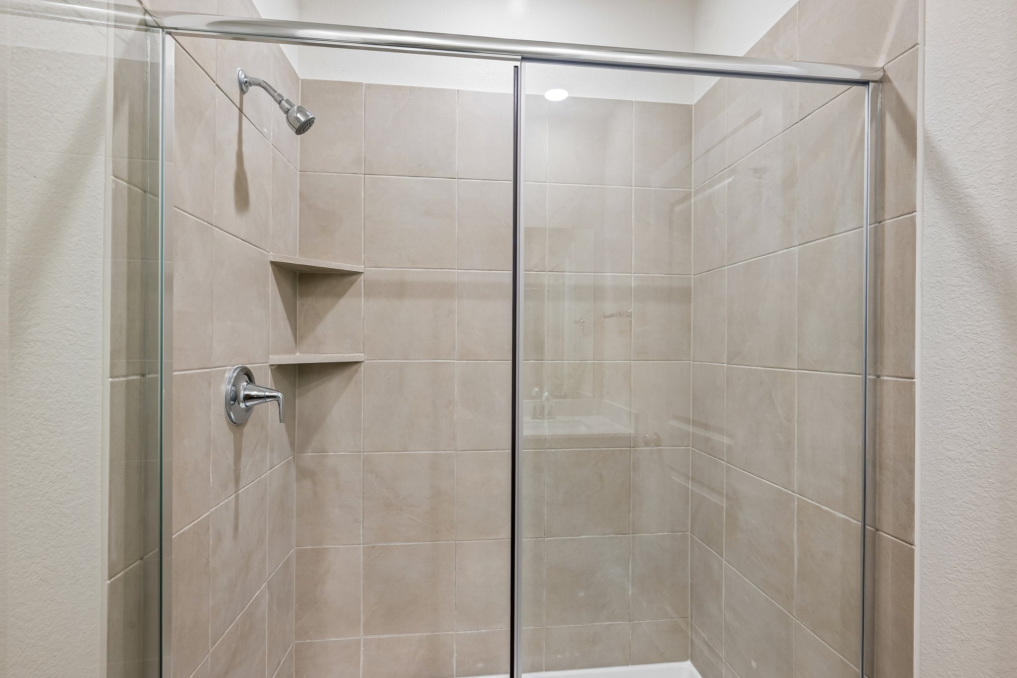 A shower with a glass door.