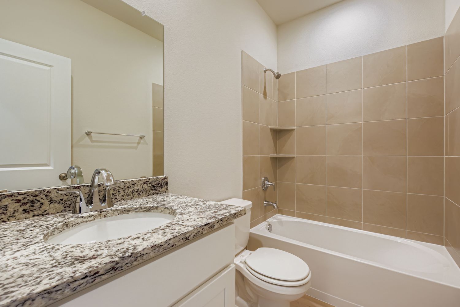 A bathroom with a marble countertop.