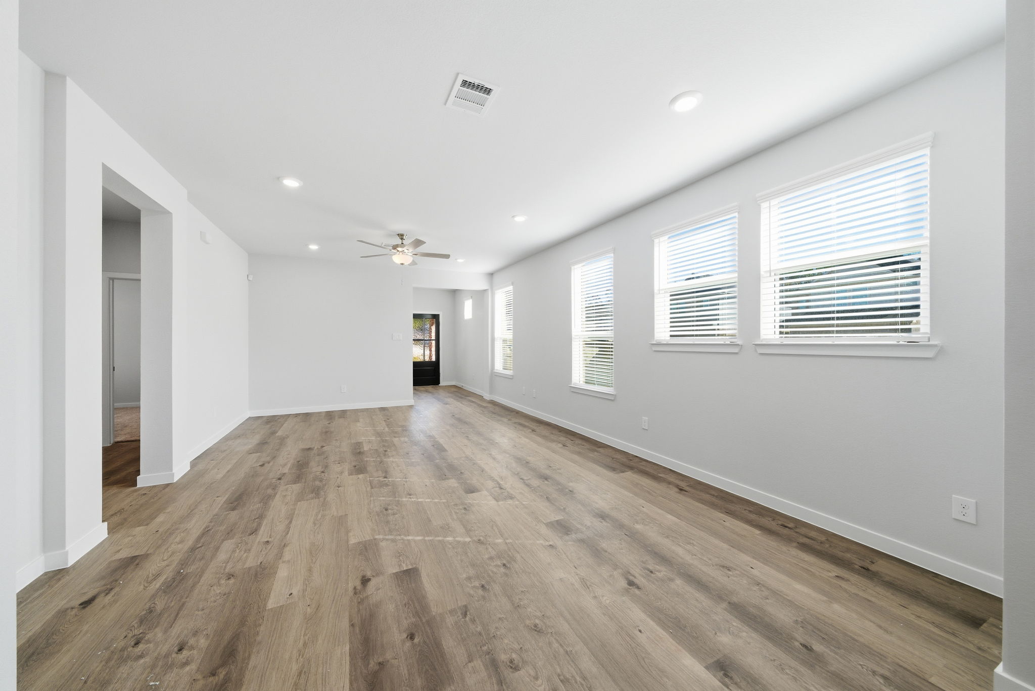 A room with a wood floor and white walls.